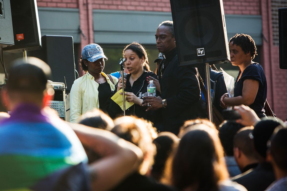 Members of Mark Carson's family speak on stage at a Rally Against Hate